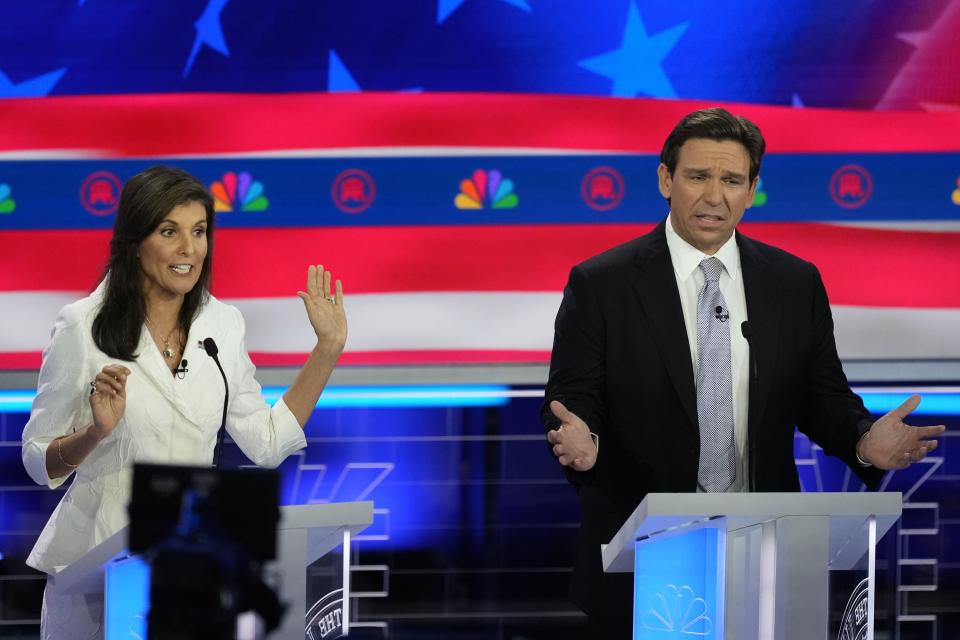 Republican presidential candidates former U.N. Ambassador Nikki Haley and Florida Gov. Ron DeSantis talk during a Republican presidential primary debate hosted by NBC News, Wednesday, Nov. 8, 2023, at the Adrienne Arsht Center for the Performing Arts of Miami-Dade County in Miami. | Rebecca Blackwell, Associated Press