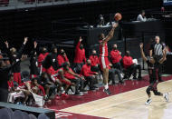 Houston's Justin Gorham, left, takes a shot over Temple's Khalif Battle (0) in the second half of an NCAA college basketball game, Saturday, Jan. 23, 2021, in Philadelphia. Houston won 68-51. (AP Photo/Michael Perez)