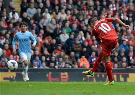 Liverpool's Philippe Courtinho (R) shoots to score against Manchester City during their English Premier League soccer match at Anfield in Liverpool, northern England April 13, 2014. REUTERS/Nigel Roddis