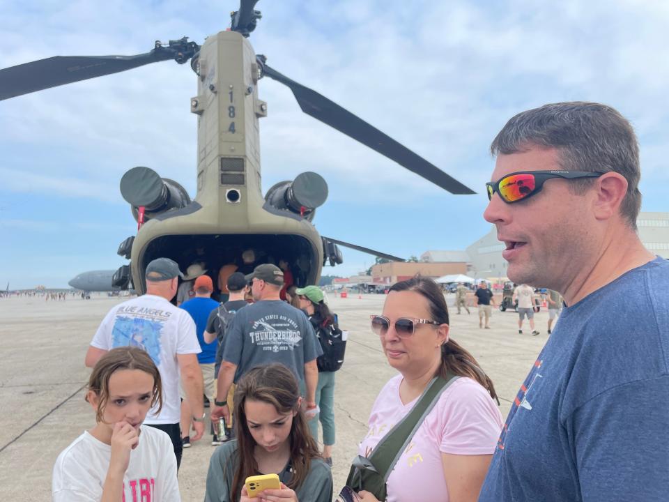 Amy and Brian McSweeney of Salem, New Hampshire, along with their two daughters, check out an Apache Army attack helicopter on display prior to the start of the Thunder Over New Hampshire Air Show at Pease Air National Guard Base in Portsmouth Saturday, Sept. 9, 2023.