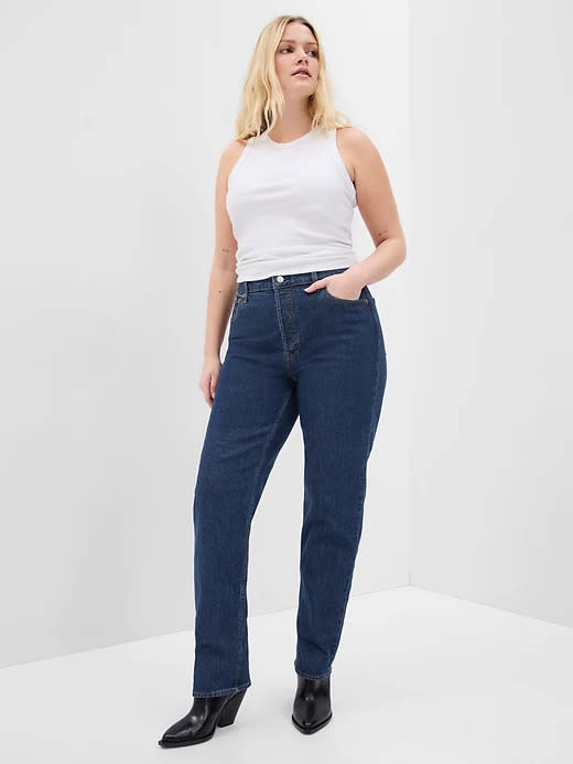 model wears dark indigo High Rise Cheeky Straight Jeans With Washwell. Image via Gap.