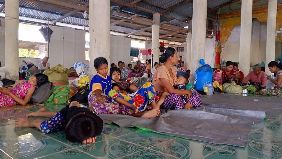 Dozens of displaced families lie on mats as they shelter at a Rakhine State monastery in November. - AFP/Getty Images