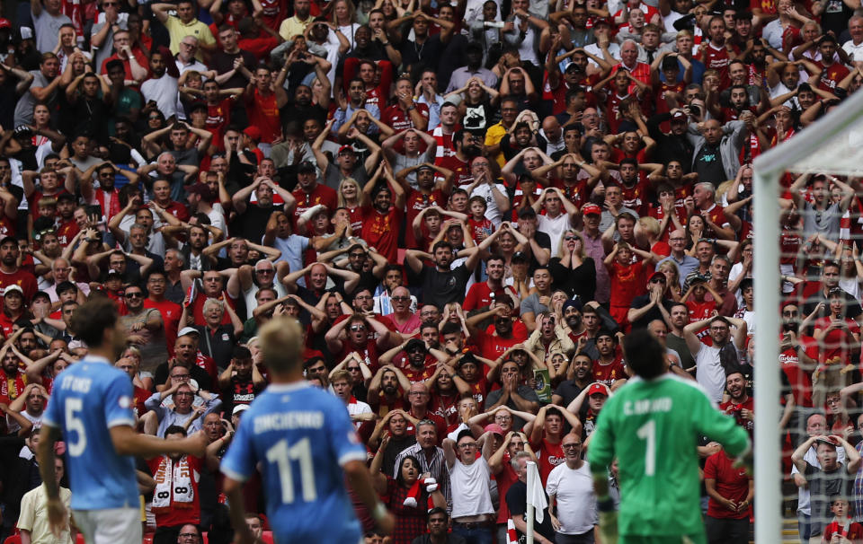 Liverpool fans react after Manchester City's Kyle Walker cleared the ball off the line from a shot by Liverpool's Mohamed Salah during the Community Shield soccer match between Manchester City and Liverpool at Wembley Stadium in London, Sunday, Aug. 4, 2019. (AP Photo/Frank Augstein)