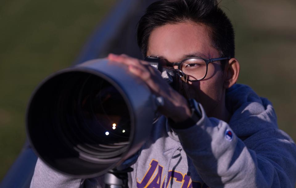 Jackson High School junior Matt Smith photographs a preseason scrimmage between the Jackson and Massillon baseball teams at Jackson High.