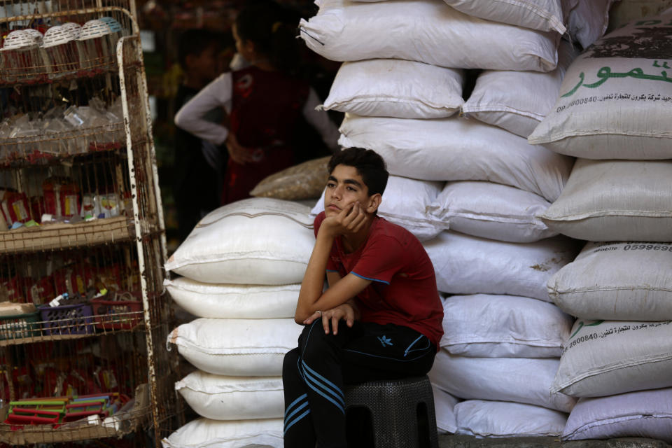 A vendor waits for customers at a grocery store during a lockdown imposed during the coronavirus pandemic, at Shati refugee camp, in Gaza City, Thursday, Aug. 27, 2020. On Wednesday Gaza's Hamas rulers extended a full lockdown in the Palestinian enclave for three more days as coronavirus cases climbed after the detection this week of the first community transmissions of the virus in the densely populated, blockaded territory. (AP Photo/Adel Hana)