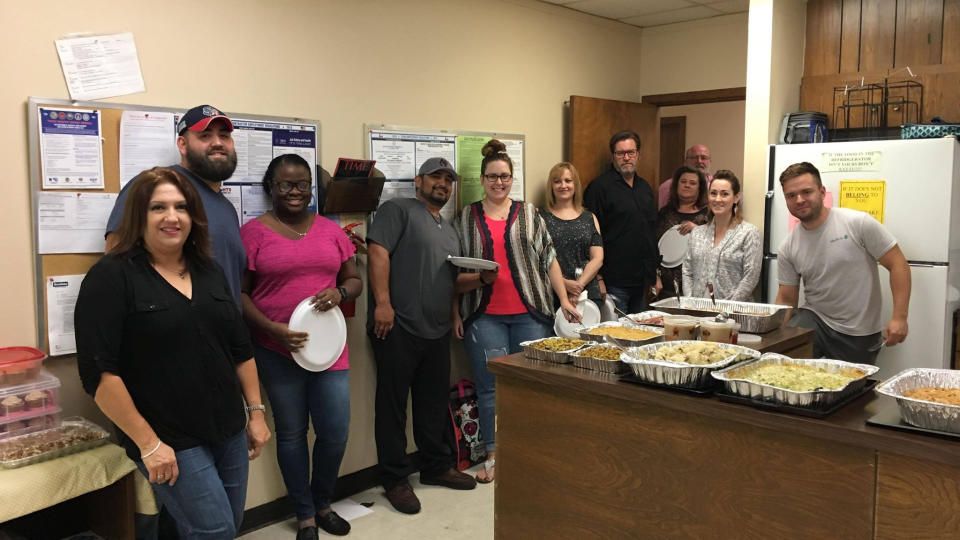 Scobey Moving & Storage team members enjoy dinner at the office.