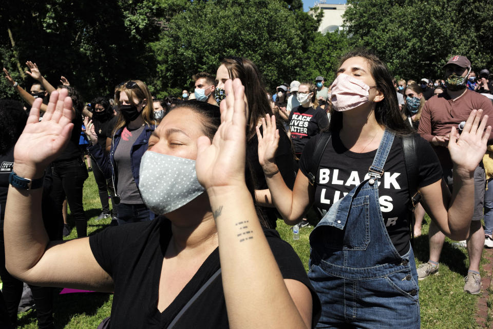 People pray during an event called "Boston Pray: Seeking Unity and Justice" held to call for end to racial injustice, Sunday, June 14, 2020, in Boston, triggered by the death of George Floyd, an African American man who died on May 25 as a Minneapolis police officer pressed his knee into his neck. (AP Photo/Steven Senne)