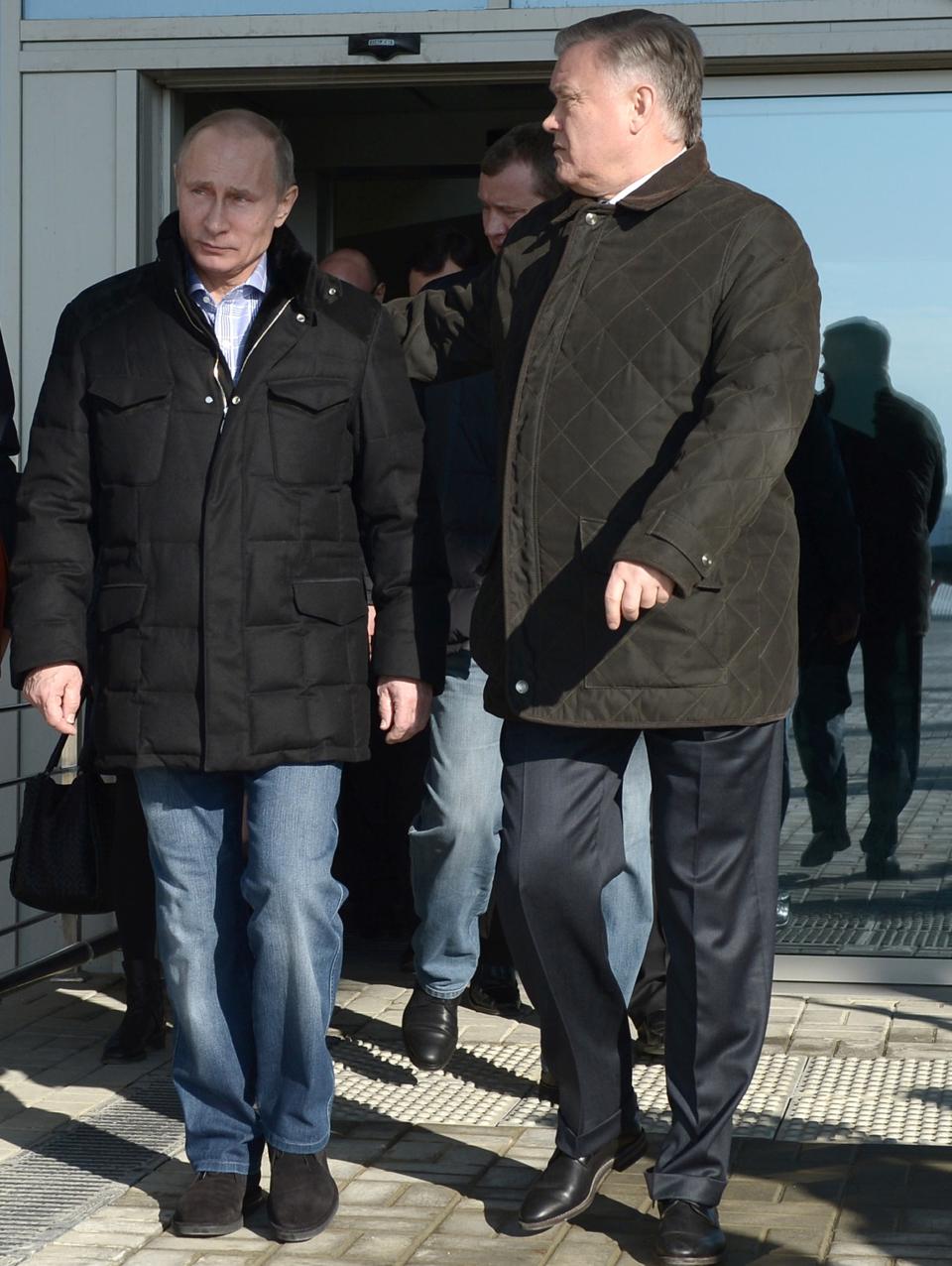 Russian President Vladimir Putin, left, and Railways Chief Vladimir Yakunin, right, visit the Olympic Park railway station at the Black Sea resort of Sochi, southern Russia, Saturday, Jan. 4, 2014. Russian President Vladimir Putin has rescinded a blanket ban on demonstrations in Sochi in and around the Winter Olympics and Paralympics. (AP Photo/RIA-Novosti, Alexei Nikolsky, Presidential Press Service)