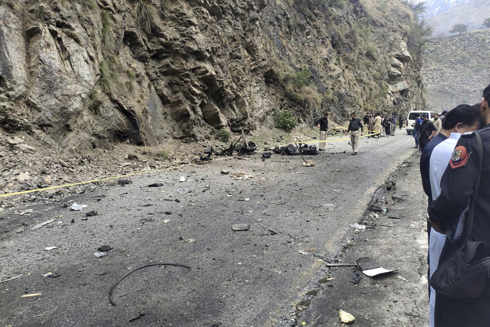 Police officers examine the site of suicide bombing at a highway in Shangla, a district in the Pakistan's Khyber Pakhtunkhwa province, Tuesday, March 26, 2024. A suicide bomber in northwest Pakistan rammed his explosive-laden car into a vehicle Tuesday, killing five Chinese nationals and their Pakistani driver, police and government officials said. (AP Photo)