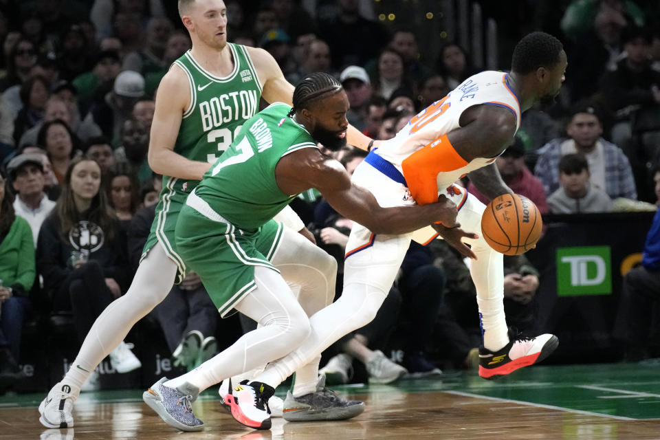 Boston Celtics guard Jaylen Brown (7) tries to stop New York Knicks forward Julius Randle (30) from driving to the basket during the first half of an NBA basketball game, Friday, Dec. 8, 2023, in Boston. (AP Photo/Charles Krupa)