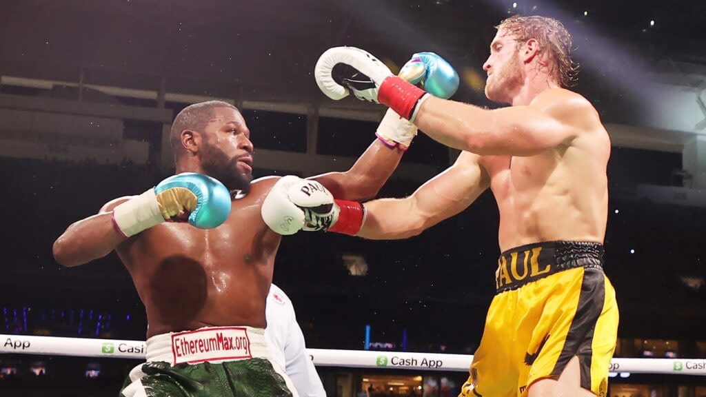 Floyd Mayweather (left) and Logan Paul exchanges blows during their exhibition boxing match Sunday at Hard Rock Stadium in Miami Gardens, Florida. (Photo by Cliff Hawkins/Getty Images)