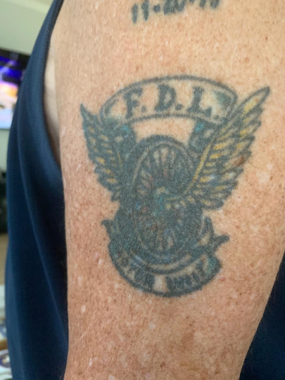 Former police officer Mick Burroughs has a tattoo from when the Fond du Lac Police Department developed the police mobile unit in 2000.