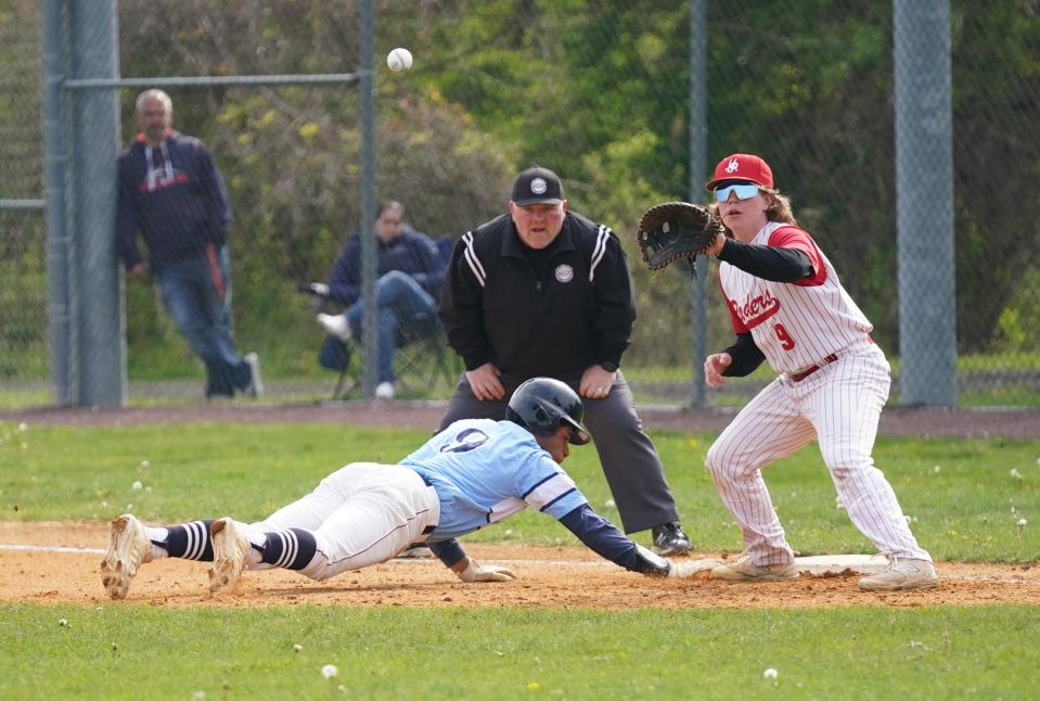 suffern base runner Conor Southwell (9) dives back on a pick-off attempt to North Rockland first baseman Nate MacAlpin during baseball action against North Rockland at North Rockland High School on Thursday, April 27, 2023.