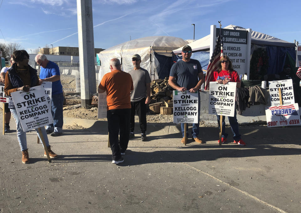 Striking Kellogg's workers stand outside the company's cereal plant in Omaha, Neb., Thursday, Dec. 2, 2021. The company and the union announced a tentative agreement Thursday that could end the strike that began Oct. 5. (AP Photo/ Josh Funk)