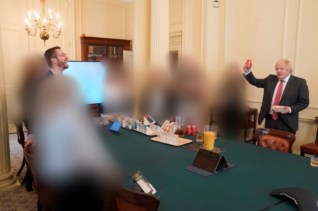 A picture of Prime Minister Boris Johnson (right) at a gathering in the Cabinet Room in 10 Downing Street on his birthday, which has been released with the publication of Sue’s Gray report (Sue Gray Report/Cabinet Office/PA) (PA Media)