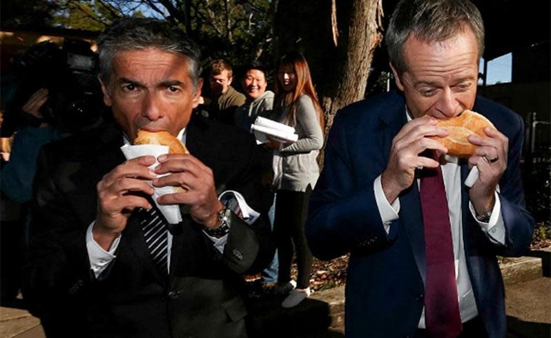 Candidate for Reid, Angelo Tsirekas, enjoys a sanga with Bill Shorten. Photo: Instagram/Alexellinghausen