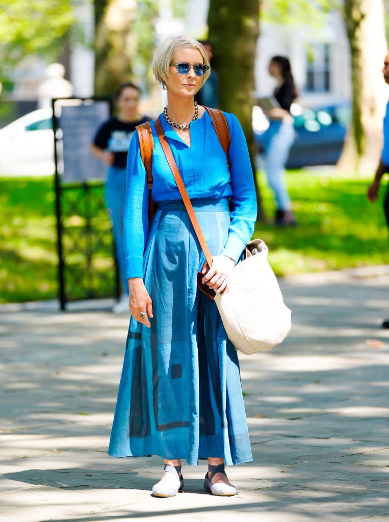 <p>Miranda goes tonal! Wearing a blue linen shier and maxi skirt, Nixon's outfit was paired with <a href="https://www.amazon.co.uk/dp/B078H33NYZ/ref=twister_B00EC9LKE0" rel="nofollow noopener" target="_blank" data-ylk="slk:Jessica Simpson ballet pumps;elm:context_link;itc:0;sec:content-canvas" class="link ">Jessica Simpson ballet pumps</a> and a cross-shoulder bag by Australian brand Elk. </p>