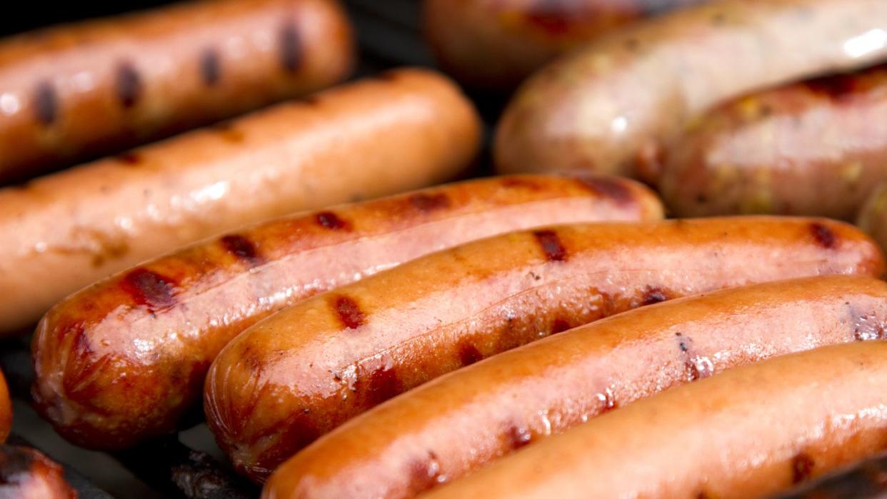 close up of grilled hotdogs on grill