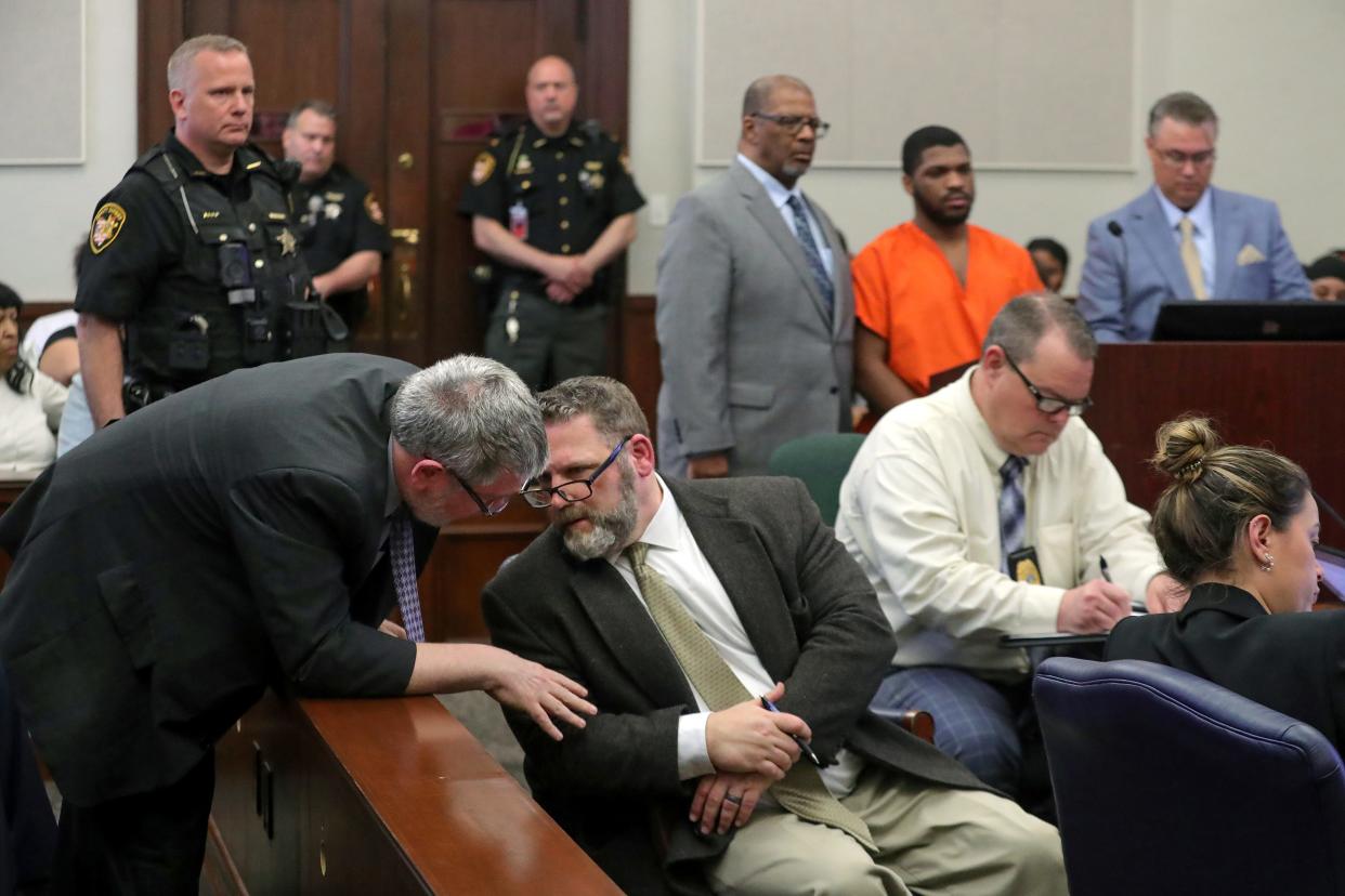 Assistant Prosecutor Kevin Mayer, center, has a word with Kevin Mayer, left, as Makhi Anderson-Clay waits for his sentence Monday with his attorneys Edward Smith and John Alexander in Judge Joy Malek Oldfield’s courtroom at the Summit County Courthouse.