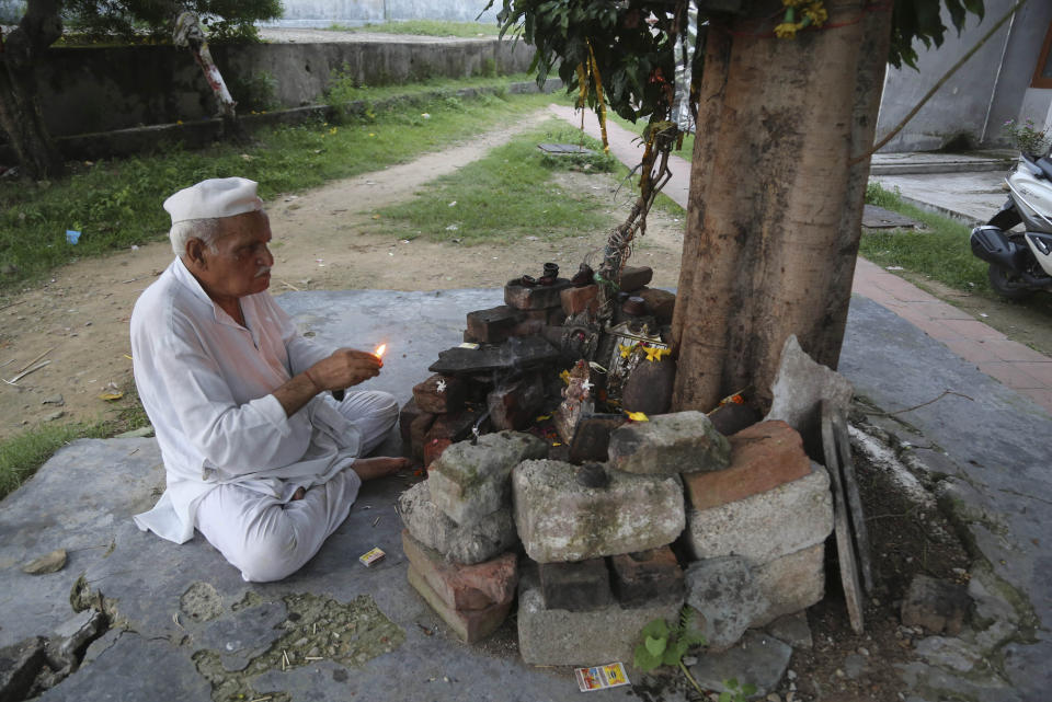 In this Aug. 29, 2019, photo, Kashmiri Hindu man, Sham Lal, 63 performs evening prayers at the Muthi migrant camp in Jammu, India. Tens of thousands of Kashmiri Hindus fled the restive region nearly 30 years ago, and the ghost of insurgency and their mass exodus still haunts them. They celebrated after India’s Hindu nationalist-led government stripped political autonomy from its part of Muslim-majority Kashmir on Aug. 5. Kashmiri Hindus view it as a step toward justice and possible return to their homeland. But many are still wary of returning. (AP Photo/Channi Anand)