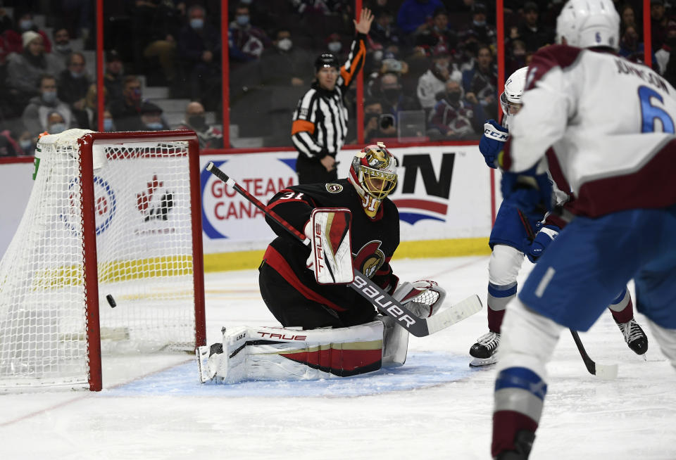 The puck enters the net behind Ottawa Senators goaltender Anton Forsberg (31) on a shot by Colorado Avalanche left wing Tyson Jost during the third period of an NHL hockey game Saturday, Dec. 4, 2021, in Ottawa, Ontario. (Justin Tang/The Canadian Press via AP)