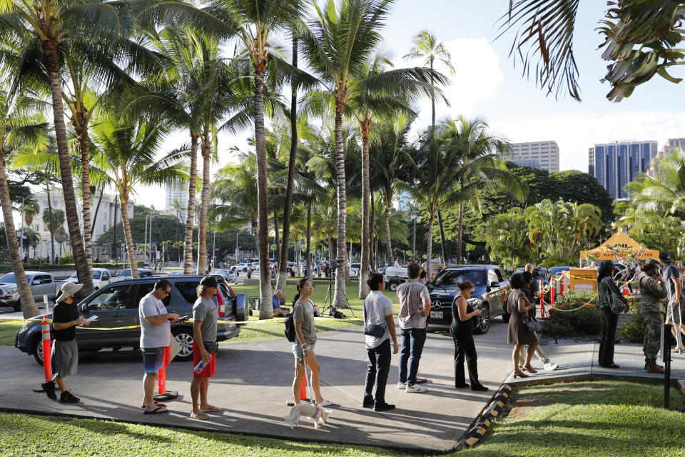 People line up outside a voting location at City Hall, Tuesday, Nov. 8, 2022, in Honolulu. (AP Photo/Marco Garcia)