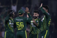 Pakistan's Shadab Khan, second right, celebrates with teammates after taking the wicket of New Zealand's Michael Bracewell during the fifth T20 international cricket match between Pakistan and New Zealand, in Lahore, Pakistan, Saturday, April 27, 2024. (AP Photo/K.M. Chaudary)