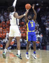 Pittsburgh guard Onyebuchi Ezeakudo (31) shoots over Virginia guard Armaan Franklin (4) during an NCAA college basketball game in Charlottesville, Va., Friday, Dec. 3, 2021. (AP Photo/Andrew Shurtleff)