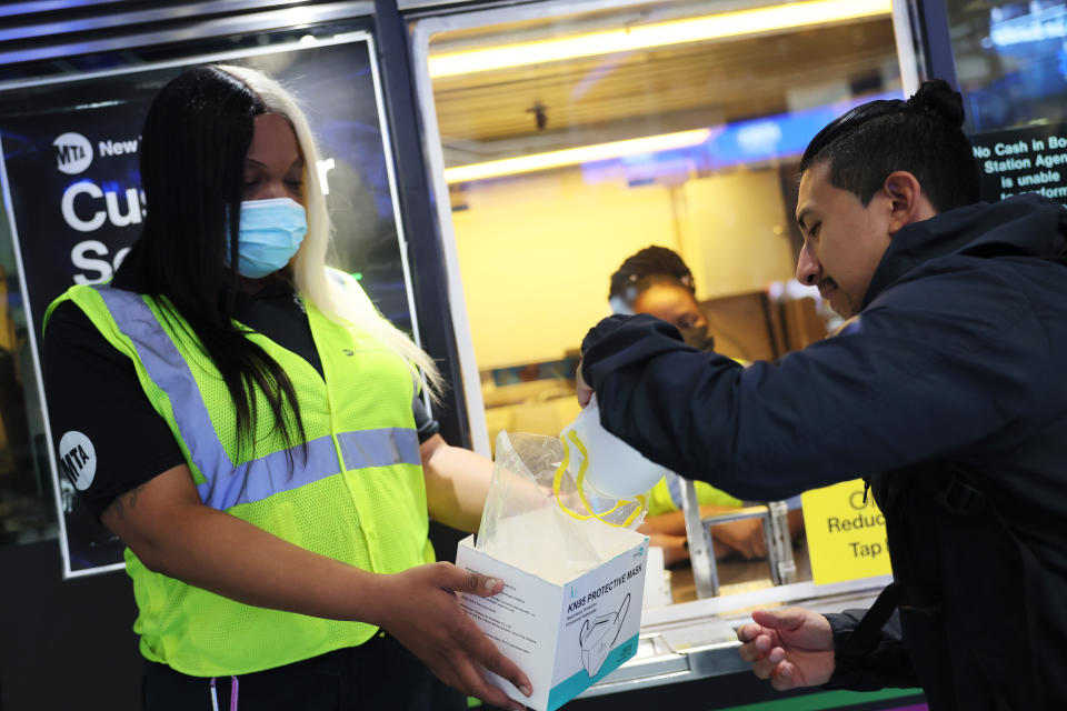 MTA employee Shanita Hancle gives out masks 