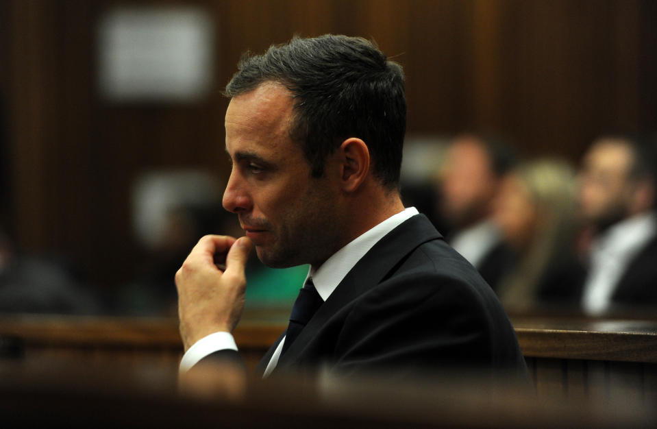 Oscar Pistorius sits in the dock as he listens to cross questioning about the events surrounding the shooting death of his girlfriend Reeva Steenkamp, in court during the second week of his trial in Pretoria, South Africa, Wedensday, March 12, 2014. Pistorius is charged with the shooting death of Steenkamp, on Valentines Day in 2013. (AP Photo/Werner Beukes, Pool)