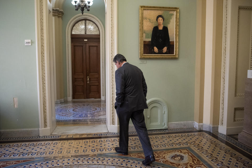 Sen. Joe Manchin, D-W.Va., walks away from the Senate chamber at the Capitol in Washington, Tuesday, Jan. 21, 2020. President Donald Trump’s impeachment trial quickly burst into a partisan fight Tuesday as proceedings began unfolding at the Capitol. (AP Photo/Cliff Owen)