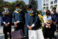 Graduates attend a ceremony to pay tribute to Chow Tsz-lok, 22, a university student who fell during protests at the weekend and died early on Friday morning, at the Hong Kong University of Science and Technology