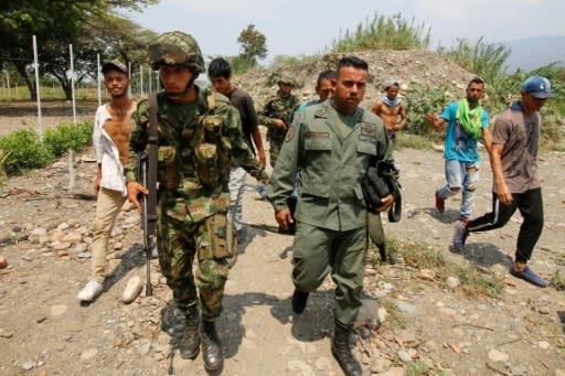 A Colombian soldier escorts a Venezuelan defector who crossed the border to Cucuta, Colombia