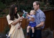 Britain's Kate, the Duchess of Cambridge, and her husband Prince William give their son Prince George a stuffed toy of Australian animal called a Bilby, which has been named after the young prince, during a visit to Sydney's Taronga Zoo, Australia Sunday, April 20, 2014. (AP Photo/David Gray, Pool)