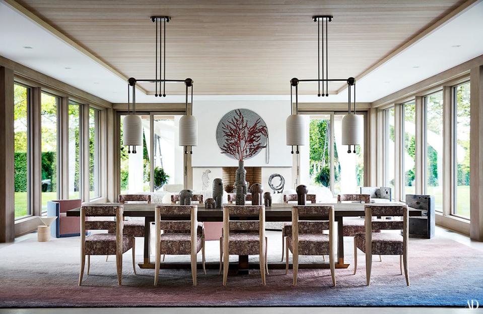 Pendants by Apparatus illuminate a custom Hudson Furniture dining table and Studio Van Den Akker chairs.