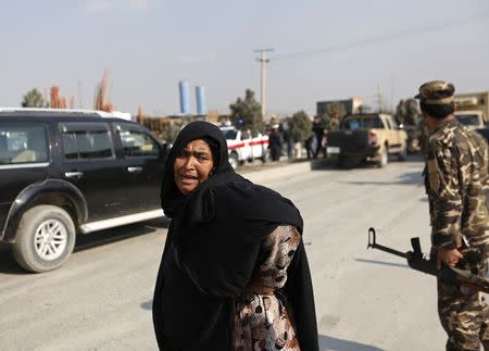 A woman mourns as she looks for her relatives at the site of a suicide attack in Kabul November 27, 2014. REUTERS/Mohammad Ismail