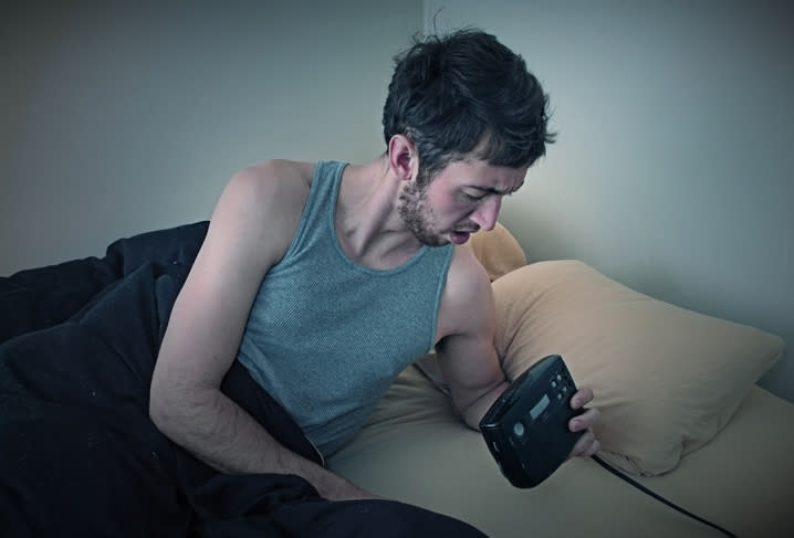 A man looks at his clock after the daylight saving change. 