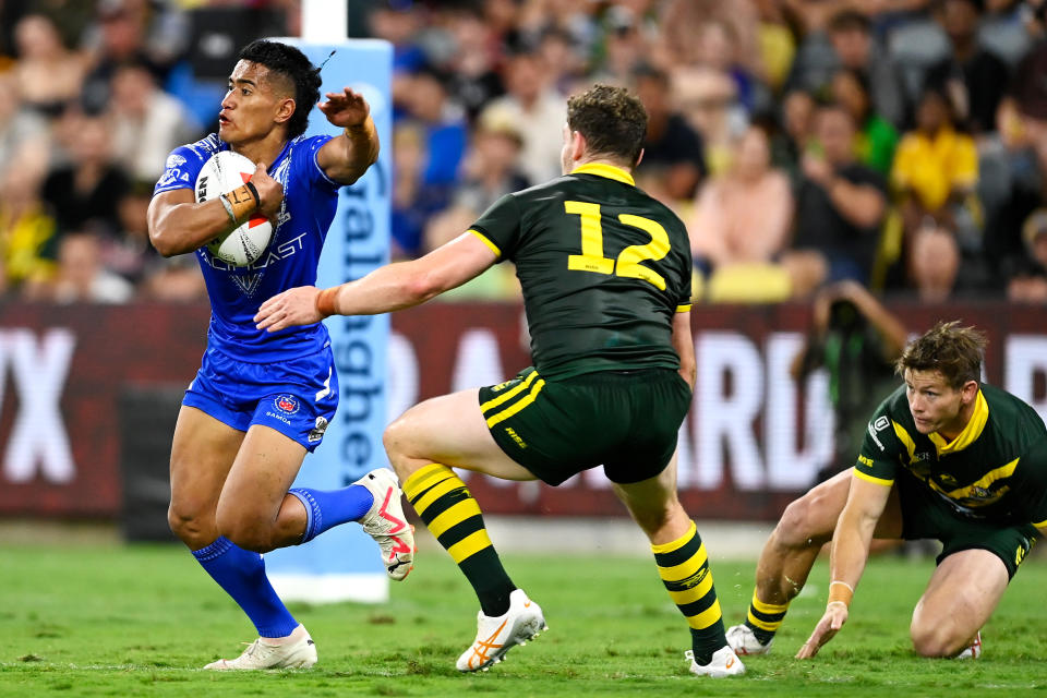 TOWNSVILLE, AUSTRALIA - OCTOBER 14: Sualauvi Faalogo of Samoa attempts to evade the Kangaroos defence during the Mens Pacific Championship match between Australia Kangaroos and Samoa at Queensland Country Bank Stadium on October 14, 2023 in Townsville, Australia. (Photo by Ian Hitchcock/Getty Images)