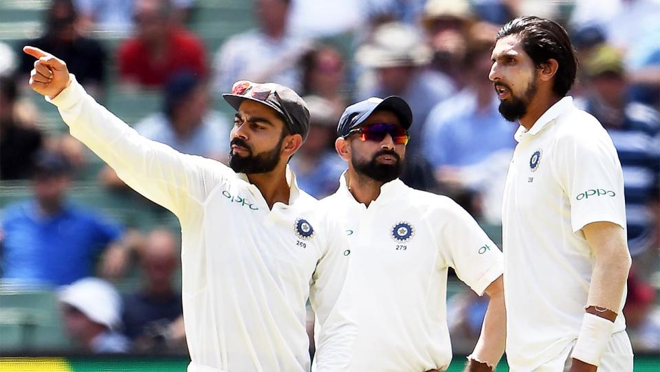 India's captain Virat Kohli (pictured left) talks to teammates Mohammed Shami (pictured middle) and Ishant Sharma (pictured right).