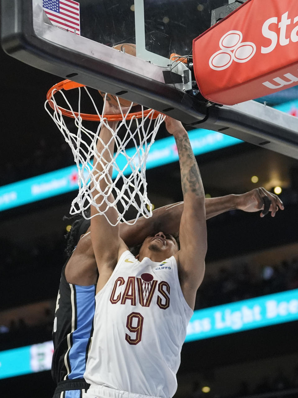 Cleveland Cavaliers guard Craig Porter (9) is fouled by Atlanta Hawks forward Bruno Fernando (24) as he scores during the second half of an NBA basketball game Wednesday, March 6, 2024, in Atlanta. (AP Photo/John Bazemore)