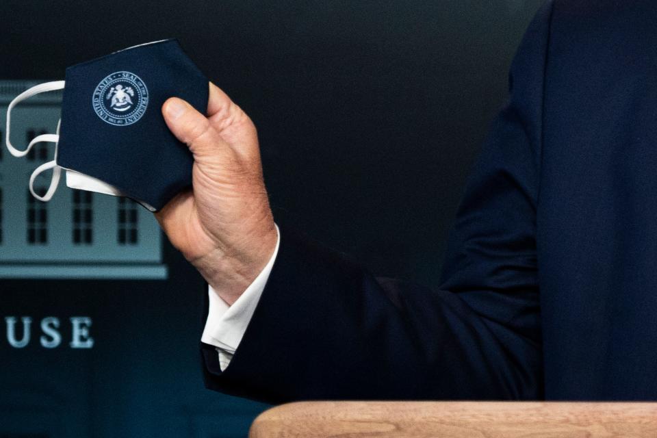 US President Donald Trump holds a mask as he speaks during the renewed briefing of the Coronavirus Task Force in the Brady Briefing Room of the White House on July 21, 2020, in Washington, DC. - Trump warned that the coronavirus crisis in the US is likely to "get worse before it gets better." "Some areas of our country are doing very well," Trump said at his first formal White House virus briefing since the end of April. (Photo by JIM WATSON / AFP) (Photo by JIM WATSON/AFP via Getty Images)