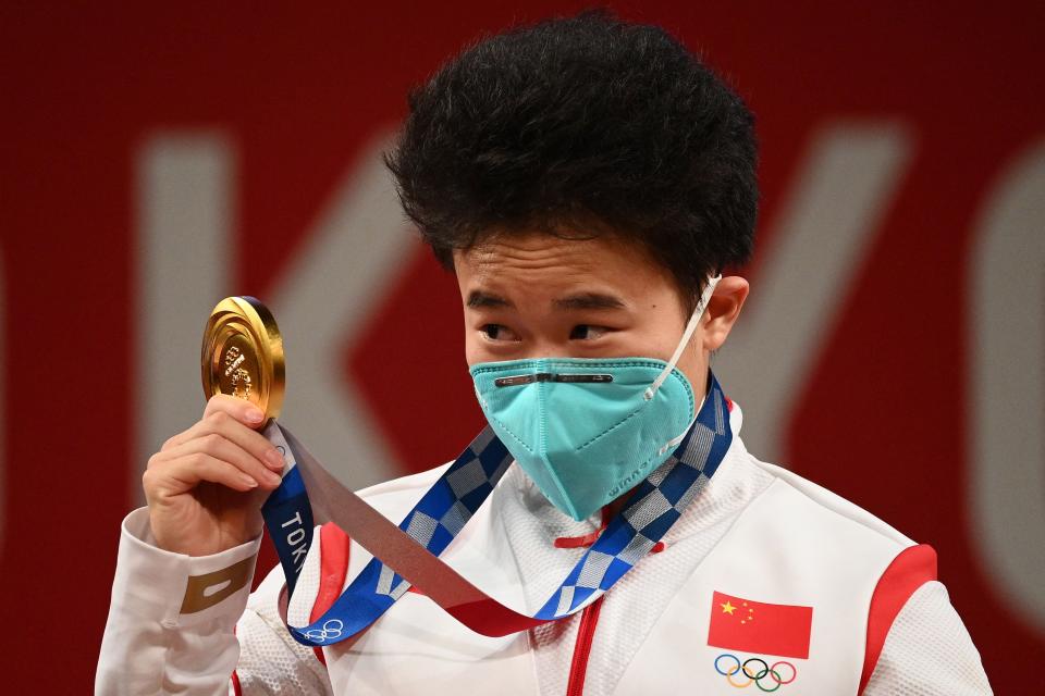 China’s Hou Zhihui stands on the podium after winning gold (AFP)