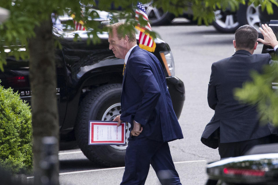 Outgoing acting Defense Secretary Patrick Shanahan arrives for a meeting with President Donald Trump about Iran carrying a folder marked secret, at the White House, Thursday, June 20, 2019, in Washington. (AP Photo/Alex Brandon)