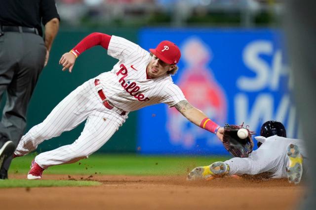 Philadelphia Phillies' Bryson Stott, right, tries to steal second