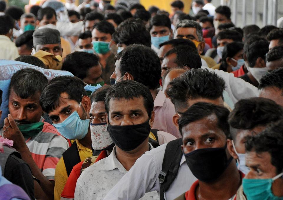 <p>Migrants wearing face masks stand in a queue for a swab test</p>SOPA Images/LightRocket via Gett