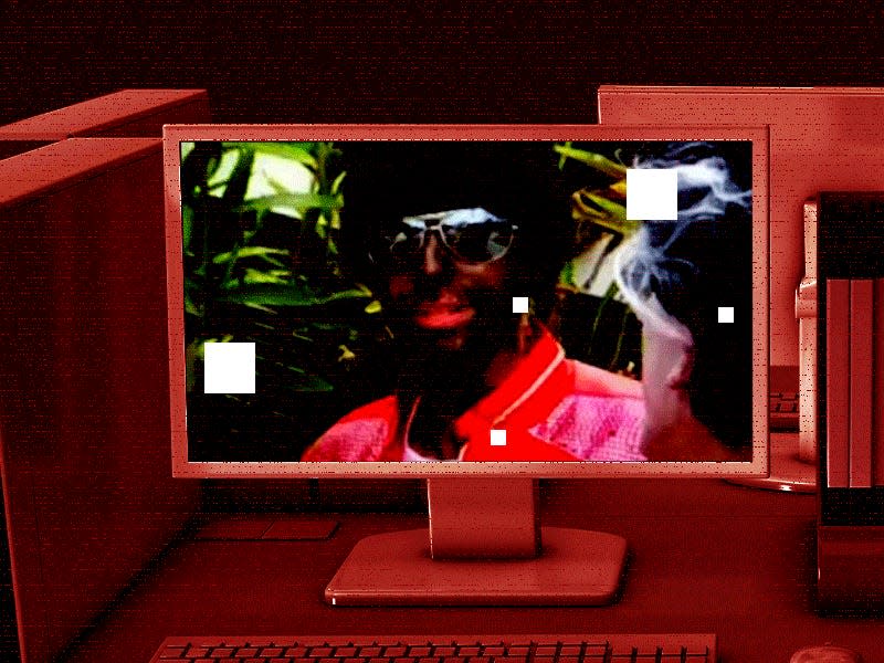Dark red office with a photo of a white employee in blackface on a computer screen, on top of the photo a pixelated version of the ROKT logo flashes