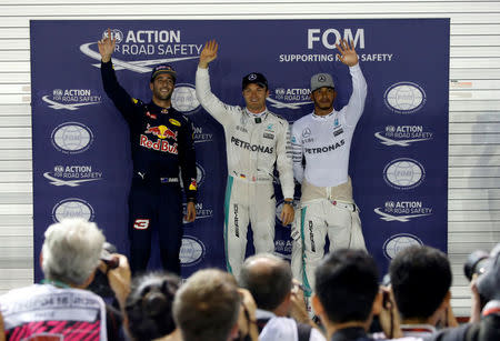 Formula One - F1 - Singapore Grand Prix - Marina Bay, Singapore- 17/9/16 Red Bull's Daniel Ricciardo of Australia, Mercedes' Nico Rosberg of Germany and Mercedes' Lewis Hamilton of Britain celebrate after the qualifying session. REUTERS/Edgar Su