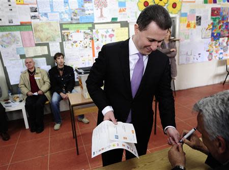 Macedonian Prime Minister Nikoa Gruevski gets his finger marked at a polling station in Skopje April 27, 2014. REUTERS/Ognen Teofilovski