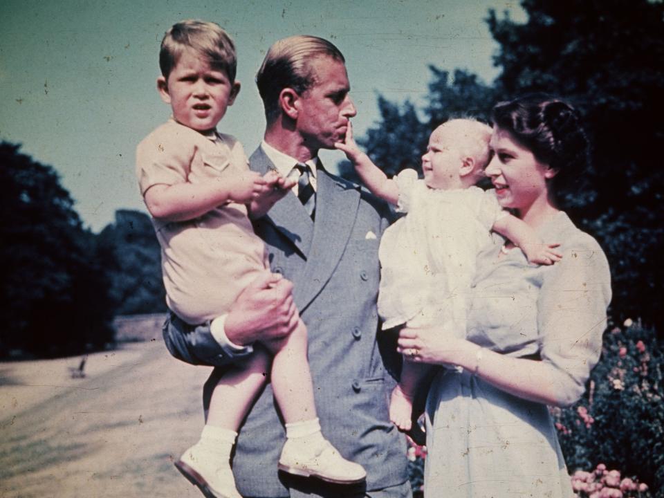 Queen Elizabeth holding Princess Anne and Prince Philip holding Prince Charles circa 1951.