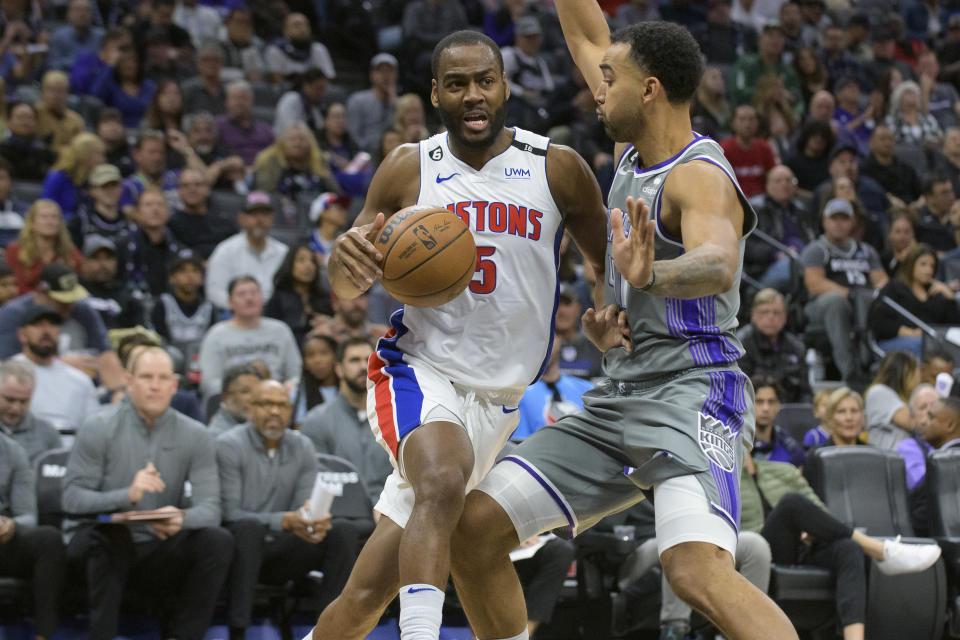 Detroit Pistons guard Alec Burks (5) is guarded by Sacramento Kings forward Trey Lyles, right, during the first quarter of an NBA basketball game in Sacramento, Calif., Sunday, Nov. 20, 2022. (AP Photo/Randall Benton)
